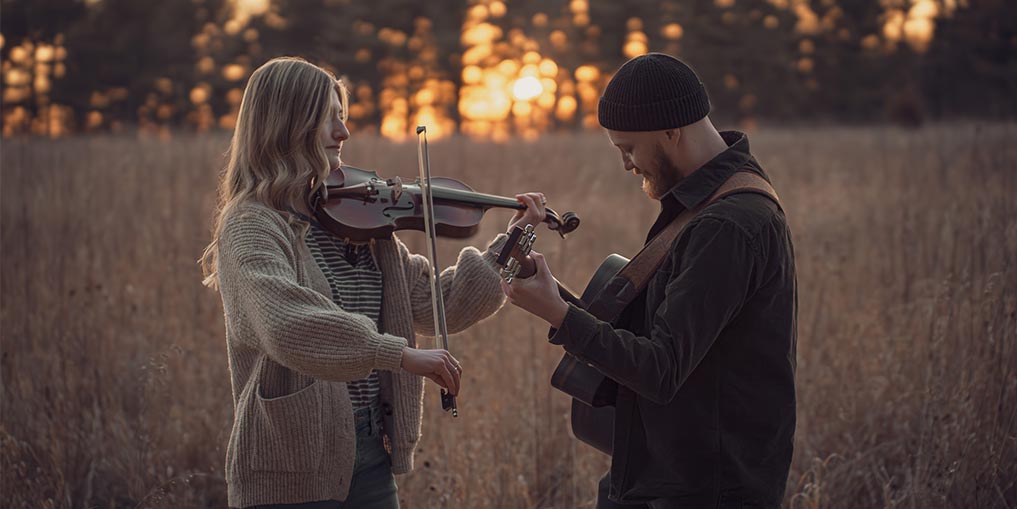 a man and woman with a sky background